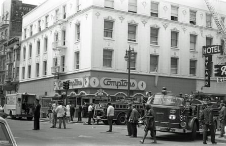 Black and white image of emergency vehicles on a city street.