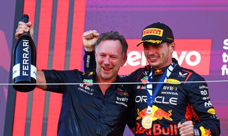 Max Verstappen and Red Bull team boss Christian Horner celebrate on the podium in Japan.