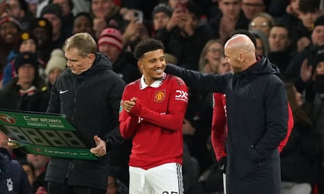 Manchester United's Jadon Sancho with manager Erik ten Hag as he comes off the bench to make a substitute appearance, his first since October.