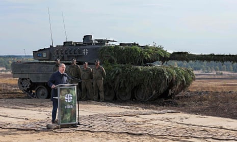 The German chancellor Olaf Scholz next to a Leopard 2 battle tank in Ostenholz, Germany, 17 October 2022. 