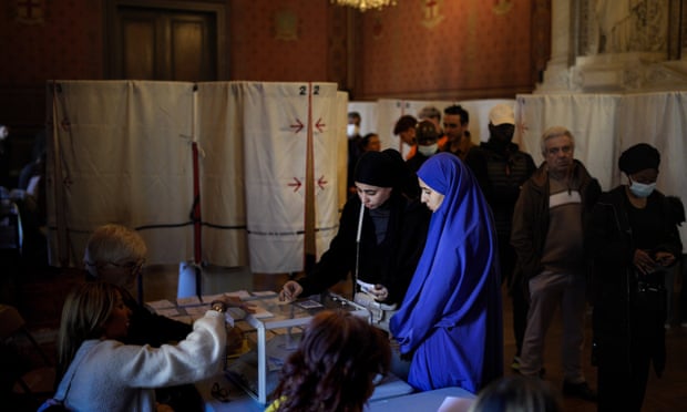 Voters casts their ballots for the first round of the presidential election in Marseille, southern France, 10 April.