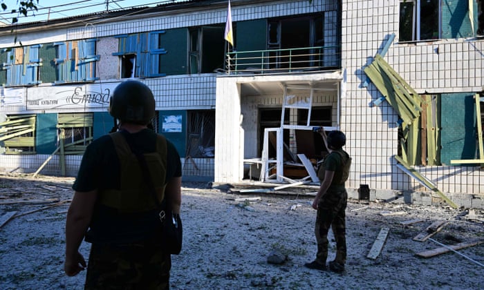 Servicemen observe the damage caused in the House of Culture in Druzhkivka following a suspected missile attack