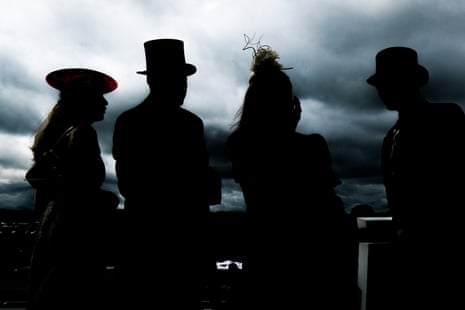 Racegoers gather under cloudy skies on Derby day at Epsom.