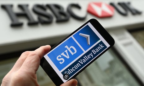 An SVB logo is shown on a smartphone outside a HSBC bank branch in London, Britain, on 13 March 2023. The HSBC Holdings financial services company has announced it has bought SVB (Silicon Valley Bank) for one British Pound. The deal protects depositors assets and prevents the US bank's UK operations from collapse. 