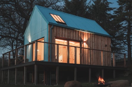 A modern designer bothy after dark in Scotland