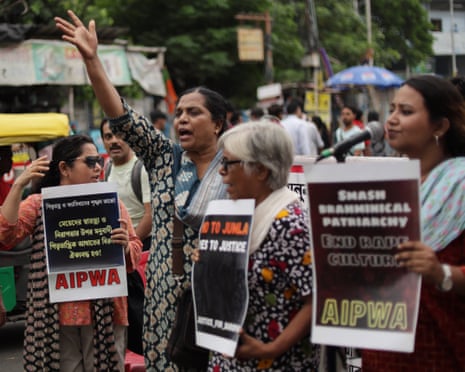 Women taking part in the protest hold up placards
