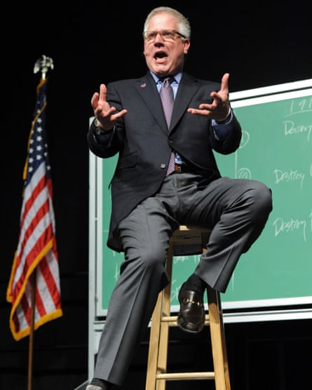 beck gestures in front of blackboard