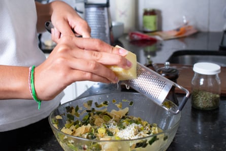 Image of a Microplane being used to grate cheese