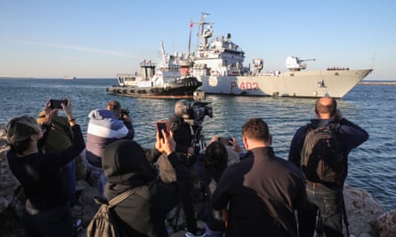 People looking at Italian navy ship on sunny day