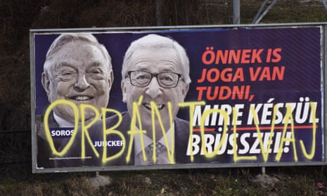 A billboard in February 2019 from a campaign of the Hungarian government showing EU Commission President Jean-Claude Juncker and Hungarian-American financier George Soros sprayed with graffiti saying ‘Orban thief,’ in reference to Hungarian Prime Minister Viktor Orban. (AP Photo/Pablo Gorondi)