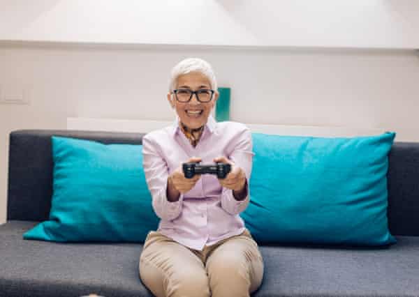 An older woman playing a video game