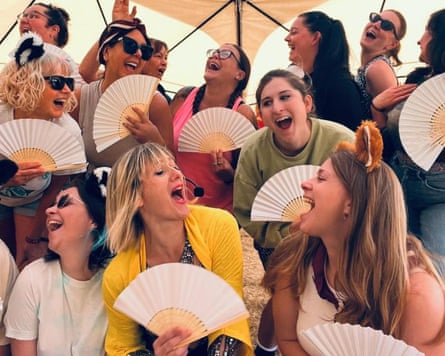 Group of women holding fans enjoying a burlesque class