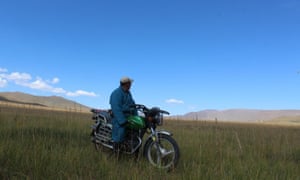 A herder on motorcycle in Bayankhongor province, Central Mongolia.