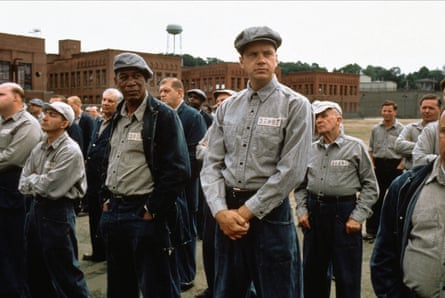 A line up of prisoners wit Tim Robbins and Morgan Freeman at the front