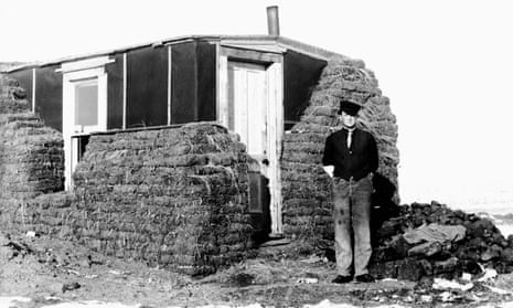 A man stands by his sod covered home in South Dakota, ca 1900.