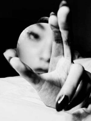 A hand and mirror reflected in a face