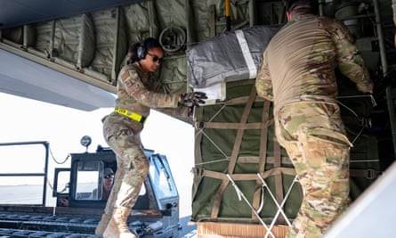 US air force personnel inspect humanitarian aid on a plane at an undisclosed location in south-west Asia