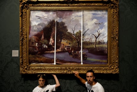 Just Stop Oil activists glue themselves to the frame of John Constable’s The Hay Wain, at the National Gallery in London, 4 July 2022.