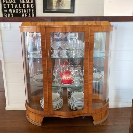 A wooden cabinet filled with crystalware