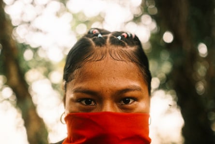 A close up of woman's face, her nose and mouth covered with a red bandana
