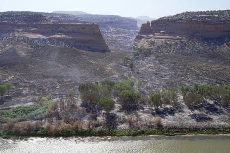 Land burned by a wildfire seen from across the Colorado river in Mack, Colorado, on 28 June 2026.