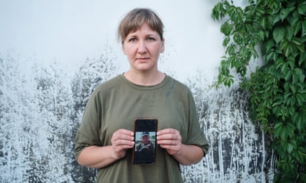 Yulia Staikutsa with a photo of her missing husband, Yevheniy.