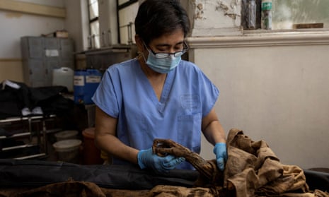 Raquel Fortun examines the exhumed remains of a ‘drug suspect’.