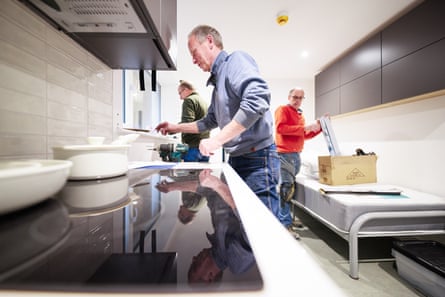 Three men doing DIY jobs in a flat