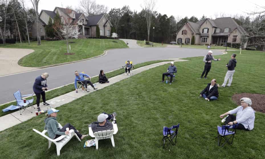 Neighbors have an informal gathering while keeping a safe distance because of the coronavirus on 22 March 2020, in Nolensville, Tennessee.
