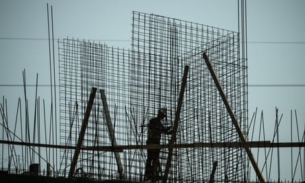 A construction worker builds concrete supports near Tel Aviv