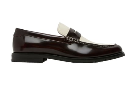The side view of a brown leather loafer. The tongue section of the show is beige. It is on a white background.