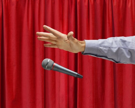 Hand of Caucasian man on stage dropping microphone