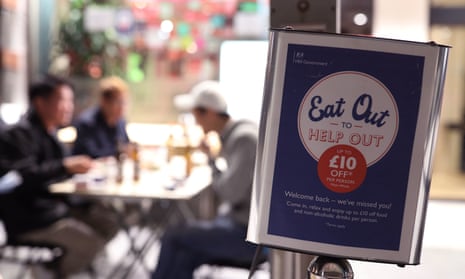 diners in soho, London, with an eat out to help out poster in the foreground