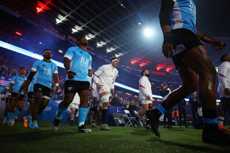 Fiji and England players take to the pitch.