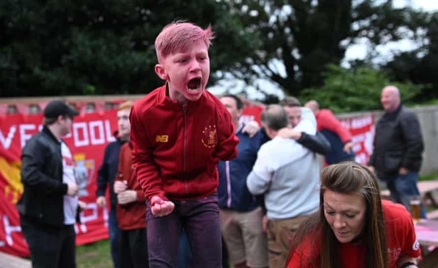 Young football fan celebrates Liverpool’s Premier League victory
