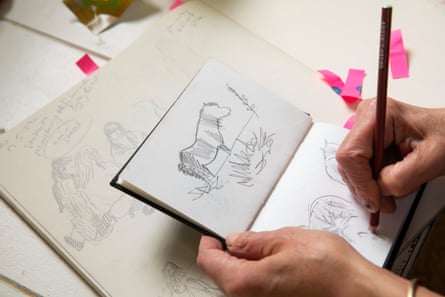 A woman’s hand drawing a picture of a pony