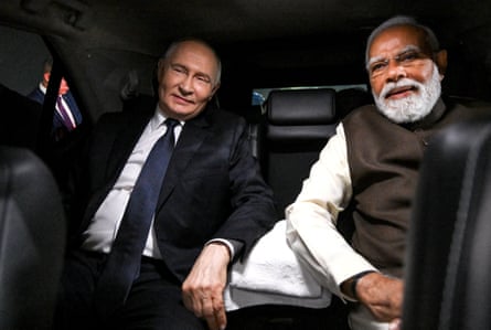 Vladimir Putin and the Indian prime minister, Narendra Modi, sit in a car during a welcoming ceremony at the Palam airbase in Delhi, last month.