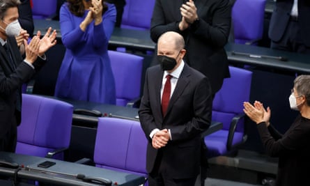 Members of parliament applaud the newly elected German chancellor, Olaf Scholz, at the Bundestag in Berlin.