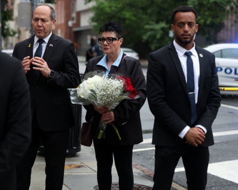 people bring flowers to leave in tribute