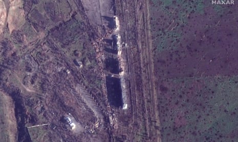Satellite view of damaged apartment buildings and cratered fields from fighting east of Bakhmut.