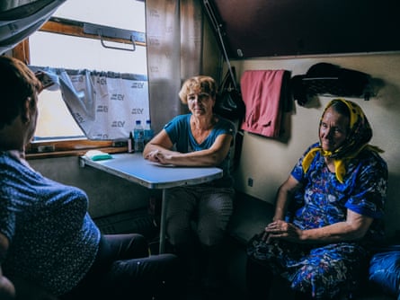 Tetiana and Nina sit in a compartment on the train