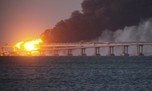 Flames and smoke rise from the Crimean Bridge connecting Russian mainland and the Crimean peninsula over the Kerch Strait, in Kerch