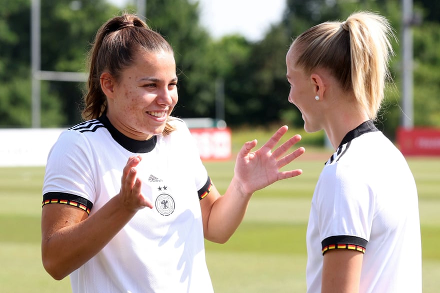 Lena Oberdorf (left) talks to teammate Lea Schüller during the official photoshoot for Germany’s Euro 2022 campaign.