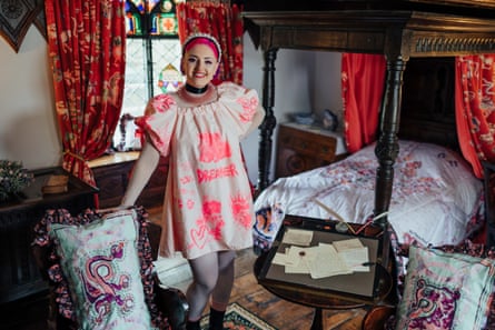 Sarah-Joy Ford among some of the textiles she has created at Plas Newydd. Her cream tunic is embroidered with ‘Dreamer’ in fuchsia thread