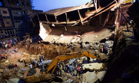 Rescue workers and onlookers at the scene of a building that collapsed in Kampala in 2009.