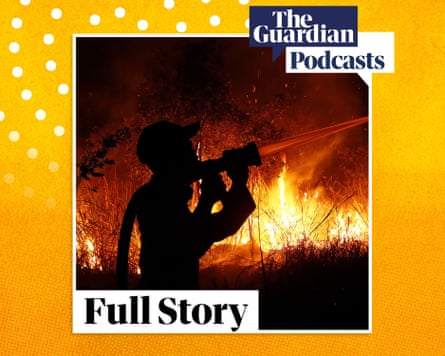 The silhouette of a firefighter attempting to put out a blazing red fire at night that burns beside them.