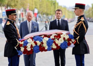 Charles and Emmanuel Macron watch as soldiers carry a wreath