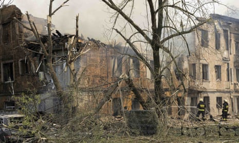 Firefighters put out the flames on the clinic in Dnipro that was hit by a Russian air strike.