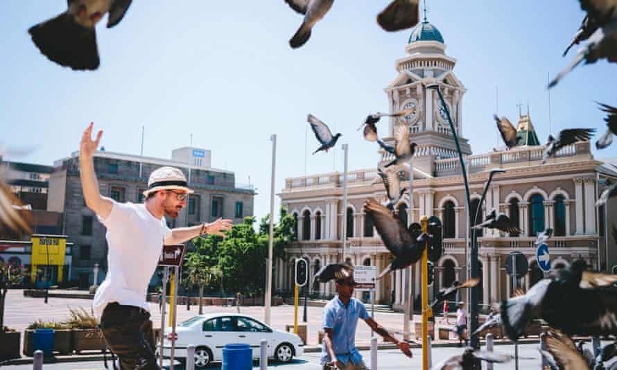 Rushay Booysen flaps at pigeons near City Hall, Port Elizabeth, South Africa