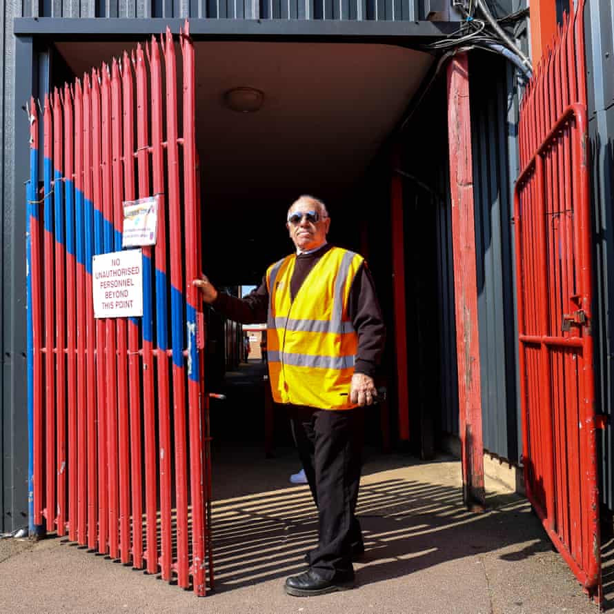 A steward guards the gates to the players entrance.